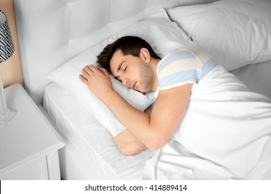 Young Man Sleeping In Bed