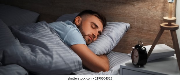 Young Man Sleeping In Bed At Night