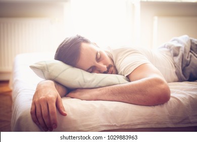 Young Man Sleeping In Bed. Space For Copy. Close Up.