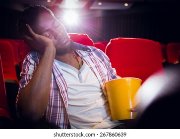 Young man sleeping in chair at the cinema - Powered by Shutterstock