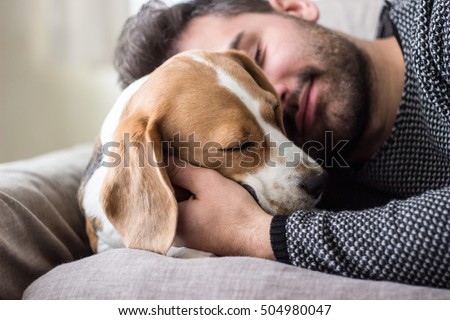  Young man sleeping with a dog 