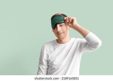 Young Man With Sleeping Mask On Green Background