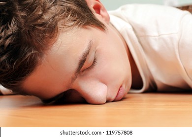 Young Man Sleeping on the Table in Home inerior