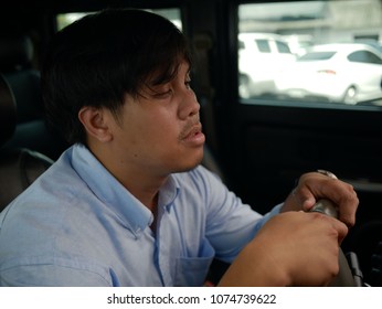 Young Man Sleepy And Driving After Work.