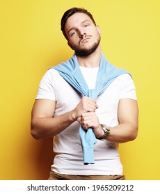 Young Man In Smart Casual Wear Looking At Camera Over Yellow Bac