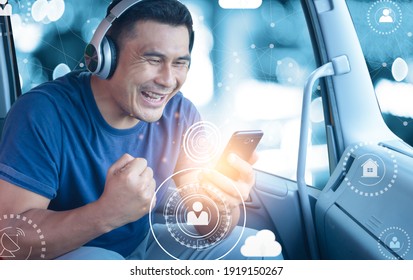 Young Man With Smartphone Connects Wireless Communication With People On Online Media. Male Asian Truck Driver Use Technology To Search For Destinations And Locations From Navigation Applications.