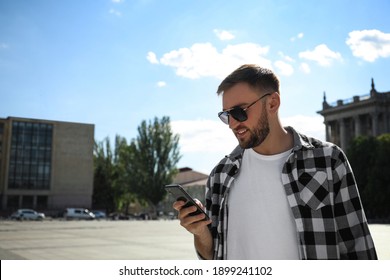 Young Man With Smartphone On City Street