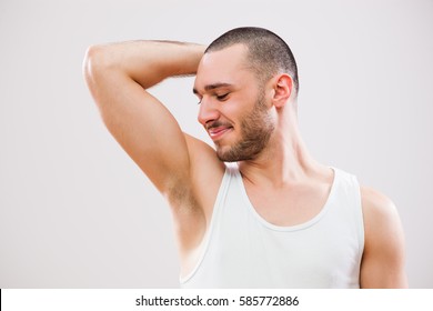 Young Man Is Smelling His Armpit After Shower.