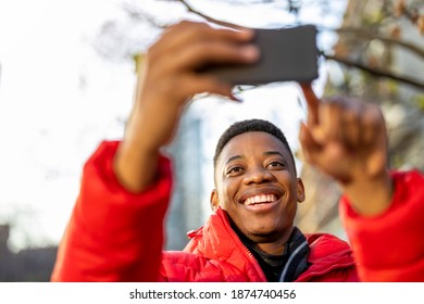 Young man smiles while video chatting with friend on smartphone outdoors
 - Shutterstock ID 1874740456
