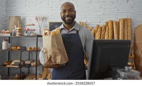 Young man smiling in a bakery while holding a paper bag filled with fresh bread, surrounded by pastry shelves under soft indoor lighting - Powered by Shutterstock