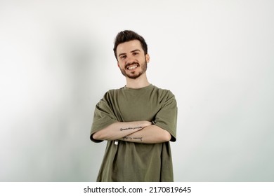 Young Man Smiling Confident Wearing Khaki Tee Posing Isolated Over White Background Smiling With Crossed Arms Looking At The Camera. Positive Person.