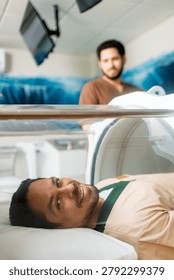 Young man smiling during hyperbaric oxygen therapy, focusing on health, well being, and medical recovery inside a chamber