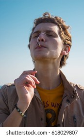 Young Man Smoking Cannabis On The Sea Background