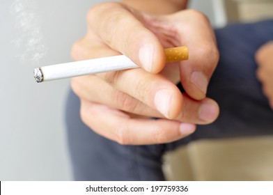 A Young Man Smoking A Cigarette