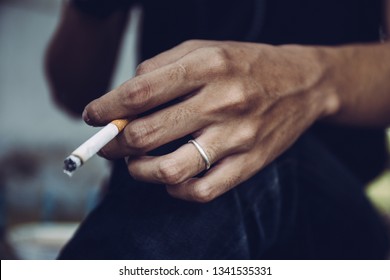 young man smoking cigarette.concept for breaking and quite cigarette for healthy. - Shutterstock ID 1341535331