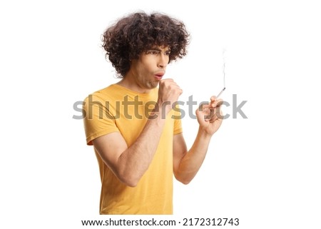 Young man smoking and coughing isolated on white background