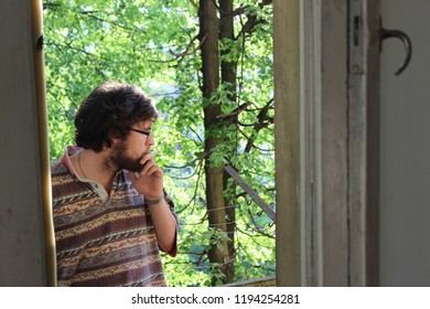 young man smoking on the  balconies - Shutterstock ID 1194254281