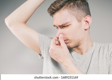 Young Man Sniffing An Armpit