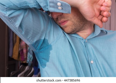 Young Man Sniffs At The Sweaty Shirt