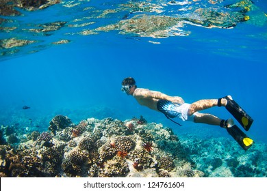 Young Man Snorkeling Underwater over Tropical Reef in Hawaii - Powered by Shutterstock