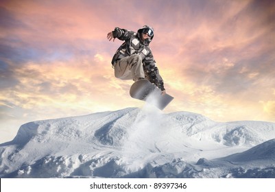 Young Man Snowboarding In The Mountains