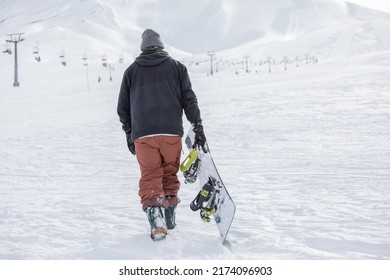 Young Man Snowboarding At The Sky Center