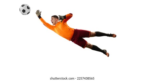 Young man, soccer football goalkeeper in sports uniform and boots catches ball in jump isolated over white background. Concept of sport, action, motion, goals. - Powered by Shutterstock