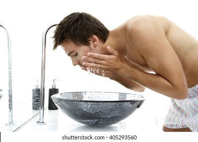 Young Man Splashing His Face With Water