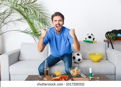 Young Man Sport Fan Watching Match In A Blue T-shirt Victory