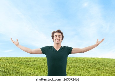 Young man spreading arms in nature