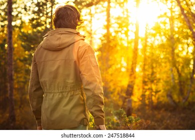 Young Man standing alone in forest outdoor with sunset nature on background Travel Lifestyle and survival concept  - Powered by Shutterstock