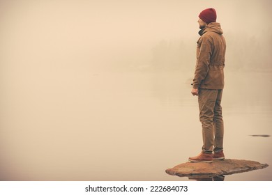 Young Man Standing Alone Outdoor With Foggy Scandinavian Nature On Background Travel Lifestyle And Melancholy Emotions Concept Film Effects Colors