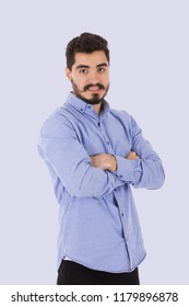 Young man standing with crossed arms smiling on a grey background. - Shutterstock ID 1179896878