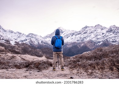 Young man standing at Dzongri top in front of Mt.Kanchenjungha Range, Sikkim. - Powered by Shutterstock