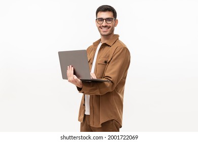 Young Man Standing Holding Laptop And Looking At Camera With Happy Smile, Isolated On Gray Background