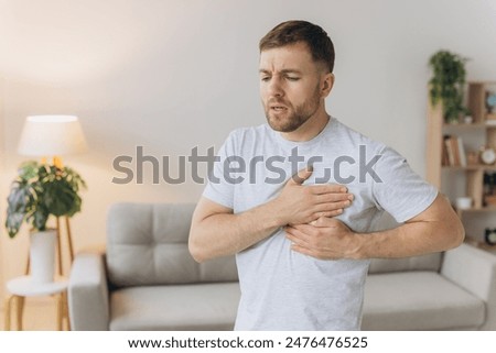 Image, Stock Photo young man holding his fiance’s hand with gold ring while making a marriage proposal with bouquet of red roses. Engagement of a young couple in love. The concept of love and togetherness.