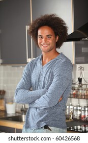 Young man standing in kitchen
