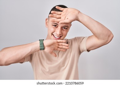Young Man Standing Over Isolated Background Smiling Cheerful Playing Peek A Boo With Hands Showing Face. Surprised And Exited 