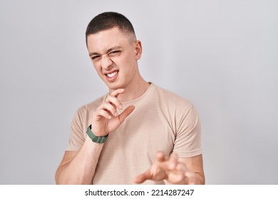 Young Man Standing Over Isolated Background Disgusted Expression, Displeased And Fearful Doing Disgust Face Because Aversion Reaction. 