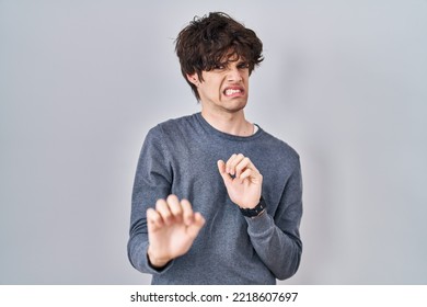 Young Man Standing Over Isolated Background Disgusted Expression, Displeased And Fearful Doing Disgust Face Because Aversion Reaction. 