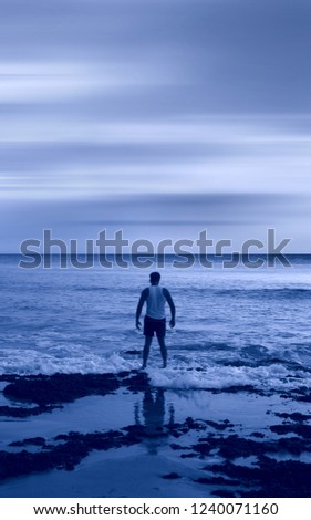 Similar – a woman looks at the sea. rear view, blurred