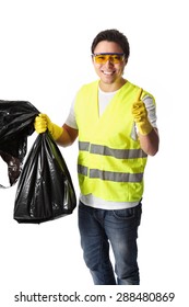 Young Man Standing Wearing A Reflective Vest, Gloves And Safety Glasses. Holding A Black Garbage Bag Doing Thumbs Up. White Background.
