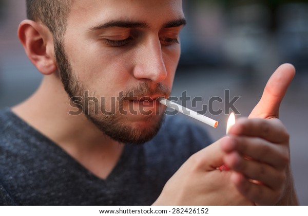 Young Man Starting Smoking Cigarette Stock Photo Edit Now