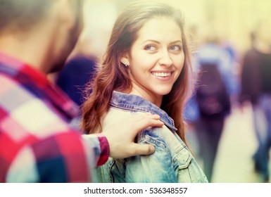 Young Man Stops A Beautiful Happy Woman On A Street To Pick Her Up