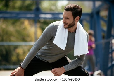 A Young Man Streching Before A Run