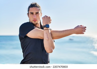 Young Man Stretching Arms At Seaside