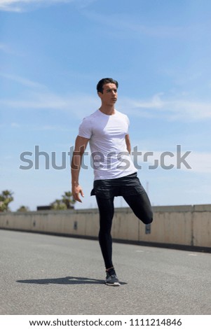 Image, Stock Photo Young man stretching in the city after jogging