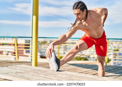 Young Man Stretching Legs At Street