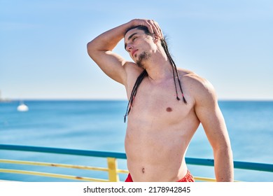 Young Man Stretching Neck At Seaside