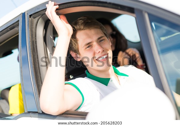 young man stuck his hand out of the window of the\
car, country car trip